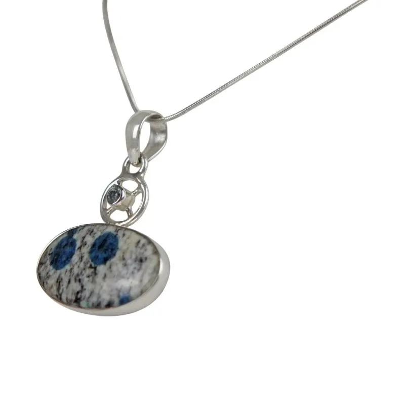 A charming Oval Shaped K2 Jasper Pendant Accent with a Tiny Blue Topaz on a Wagon Wheel
